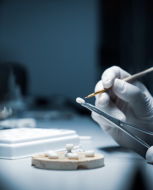 Lab technician working on dental crowns