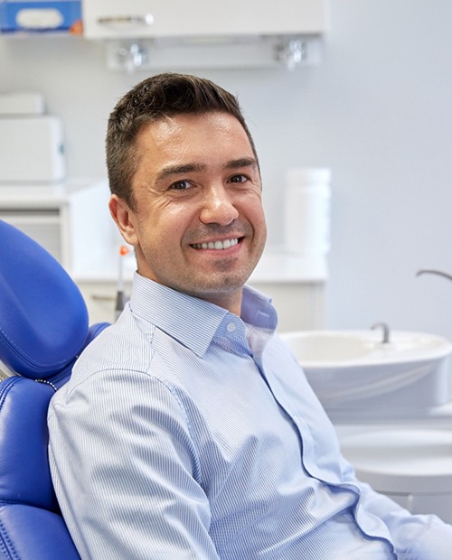 Male dental patient sitting in chair waiting for treatment