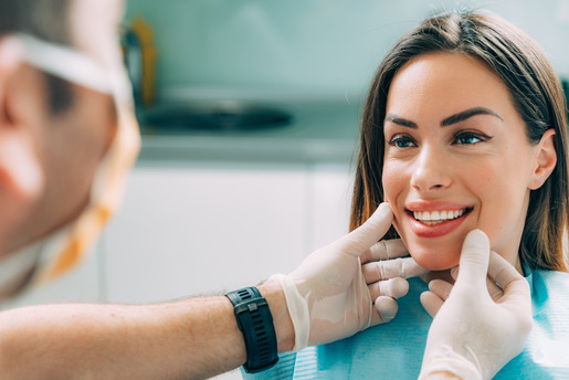 patient smiling while visiting cosmetic dentist 