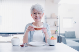 Older woman about to enjoy a meal with her dentures